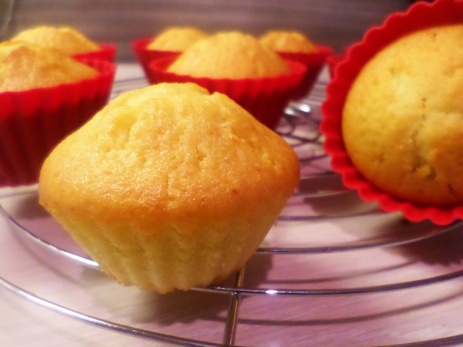 Golden and delicious orange cupcake made with fresh orange juice and baked in a reusable cupcakes red silicone molds