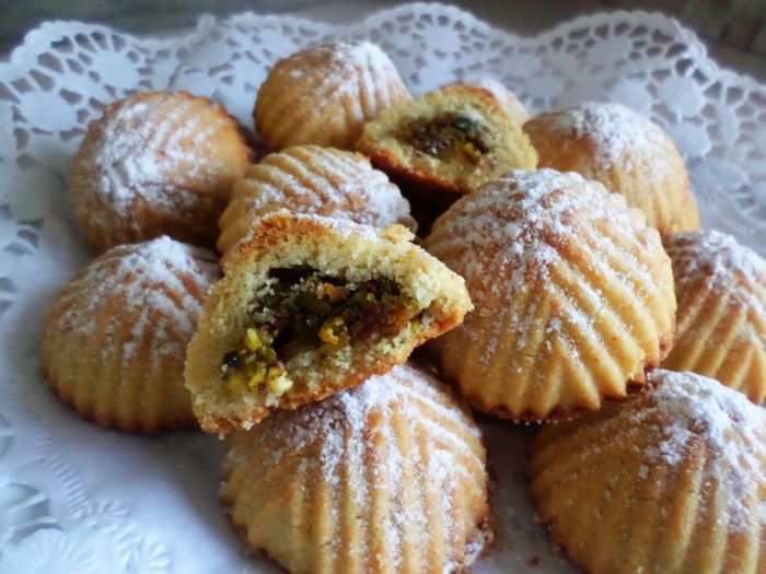 These golden Best Pistachio Cookies (Maamoul with pistachio) is covered with powdered sugar served in a beautifully desserts dantail sheet