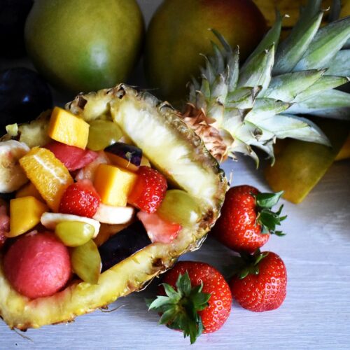 fuit salad served in a pinapple shell