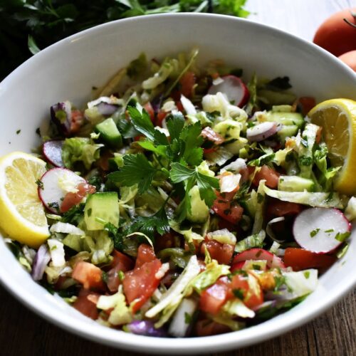 White bowl with fresh vegetable salad