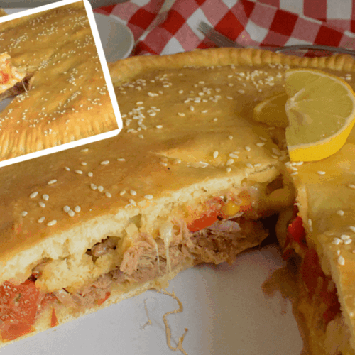 Delicious Veggie Tuna pie served in a white plate topped with 2 slices of lemon