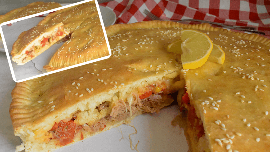 Delicious Veggie Tuna pie served in a white plate topped with 2 slices of lemon